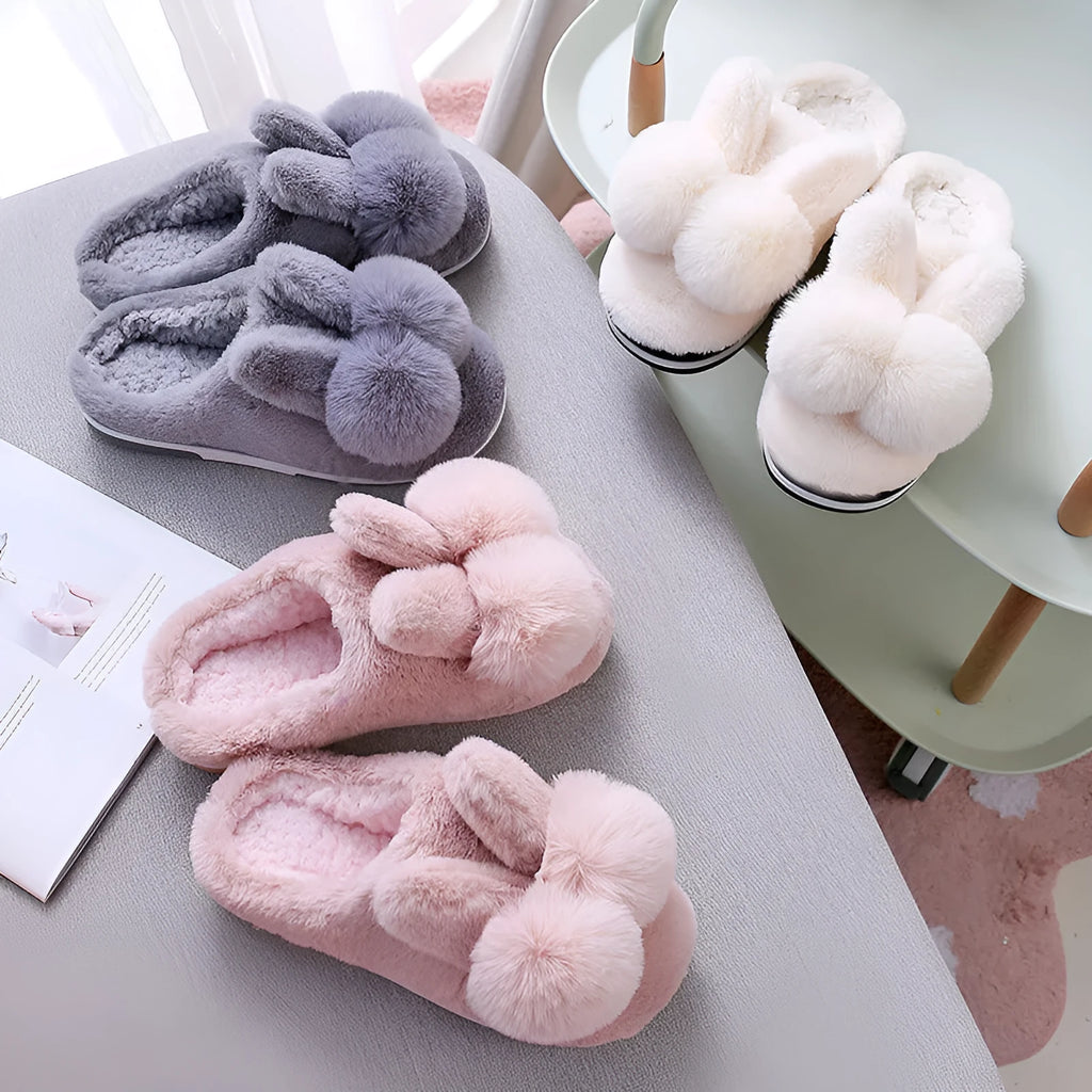 Women's rabbit fur winter slippers with high upper, floral detail, and sewn sole in creamy white.