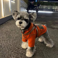 Red polyester hooded sweater for small dogs with two feet openings on a neutral background