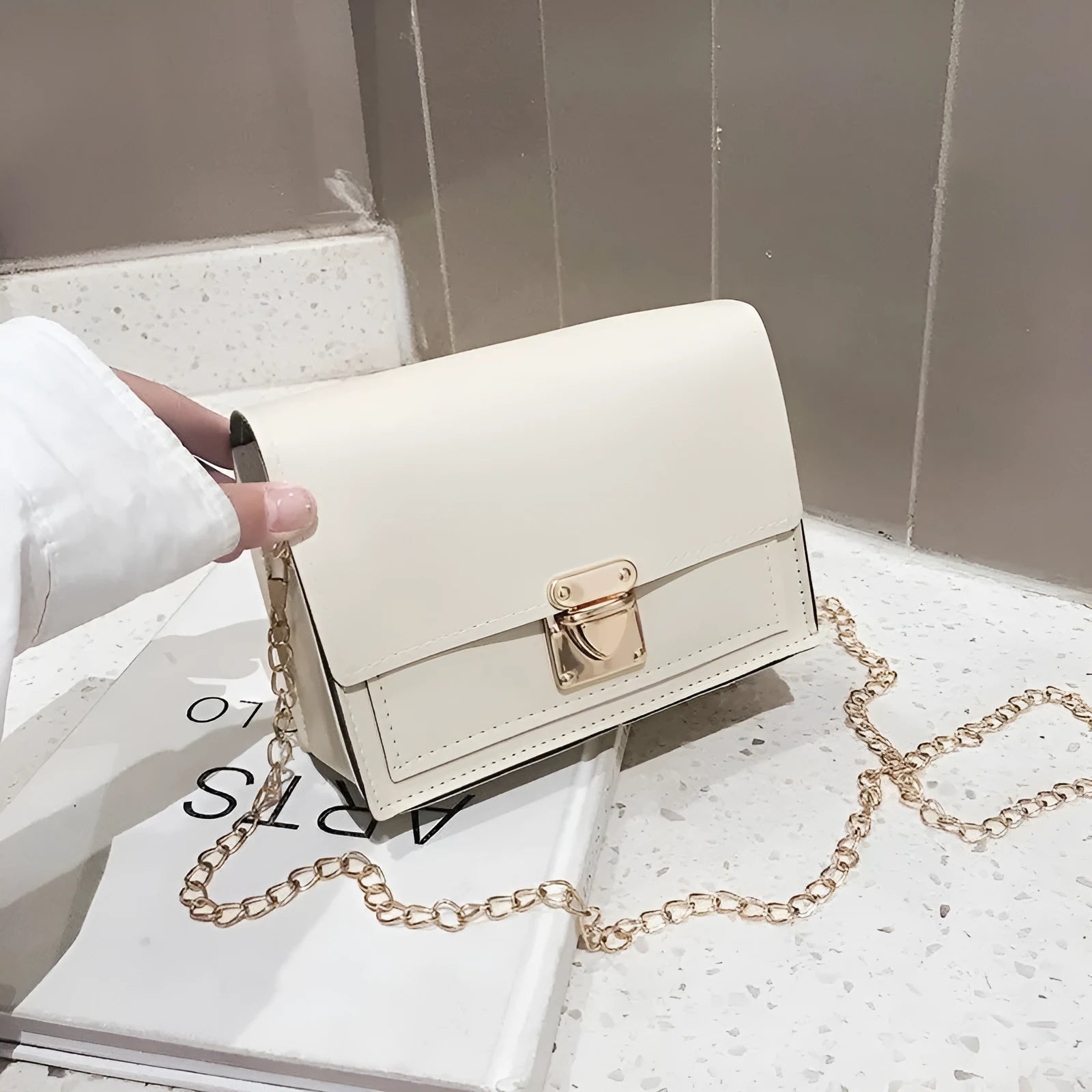 Women's small square messenger bag in PU leather with chain strap and cover flap closure