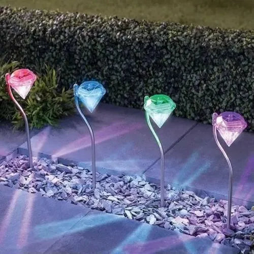 White solar-powered diamond-shaped garden light with adjustable angle and solar panel on top.