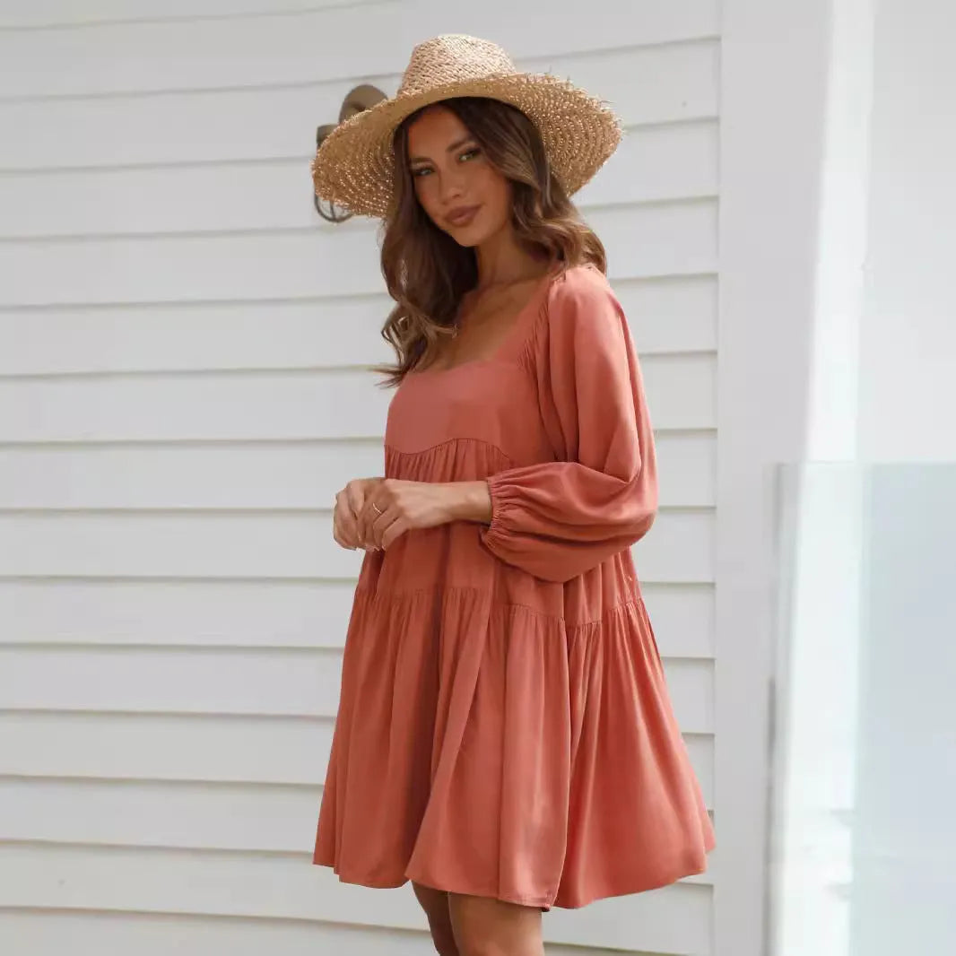 Girl in an orange red backless dress with a square collar and puff sleeves, showcasing the A-line skirt.