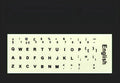 Yellow glowing keyboard stickers showing Arabic, Thai, Hebrew, French, Italian and German characters on PVC sheet