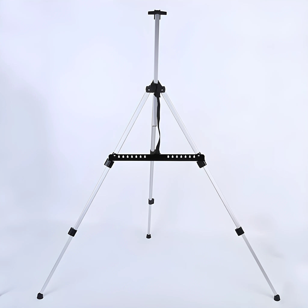 Silver aluminium alloy adjustable easel with metal tray in collapsed position on a tabletop