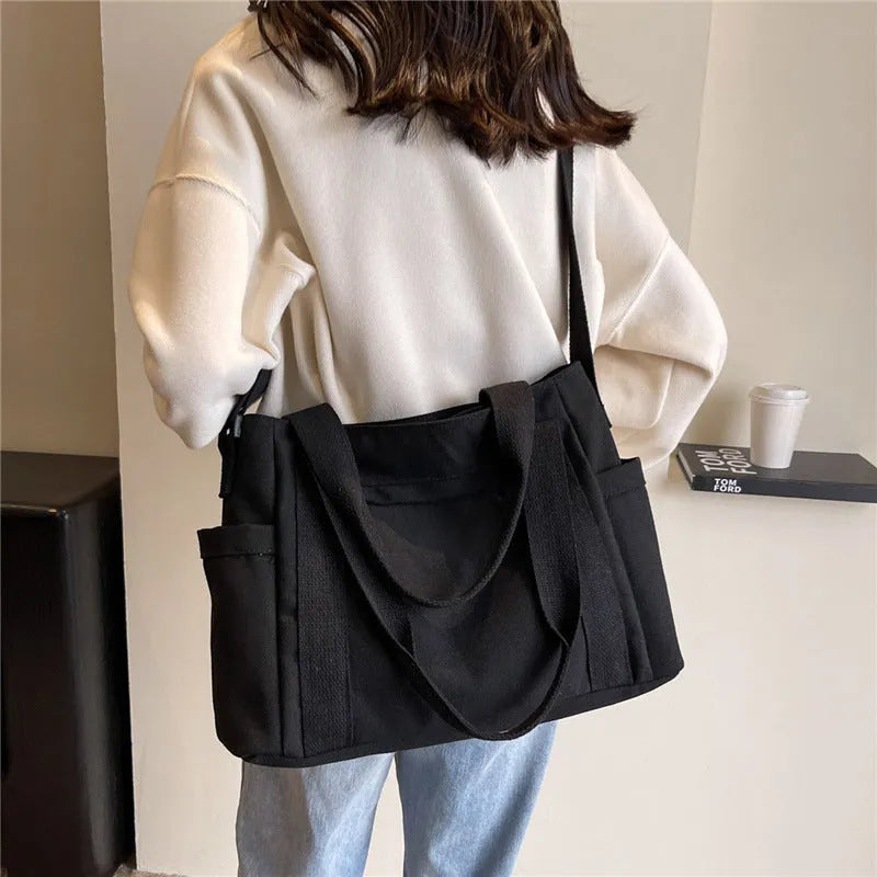 Large canvas shoulder tote bag in solid colour with sandwich pocket organisation