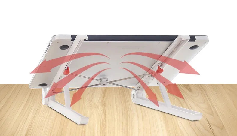 White foldable laptop bracket with heat sink base on a desk.