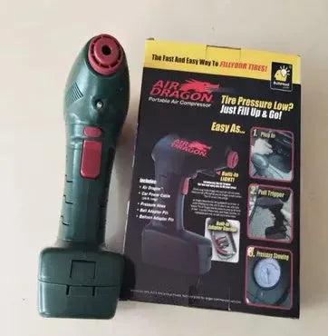 Compact black 12V portable car tyre pump with digital display, LED light, hose, and valve adapters on a grey background.
