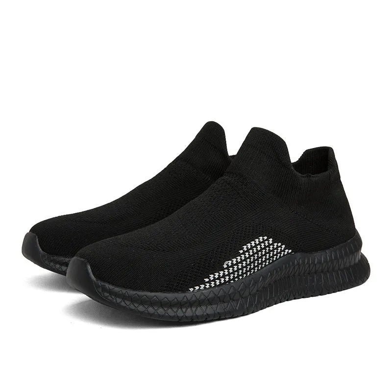 Popcorn flyknit fabric casual sneaker in black, low top with round toe and flat heel.