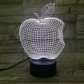 Colourful 3D fruit-shaped acrylic LED night light with touch controls on a dark surface.