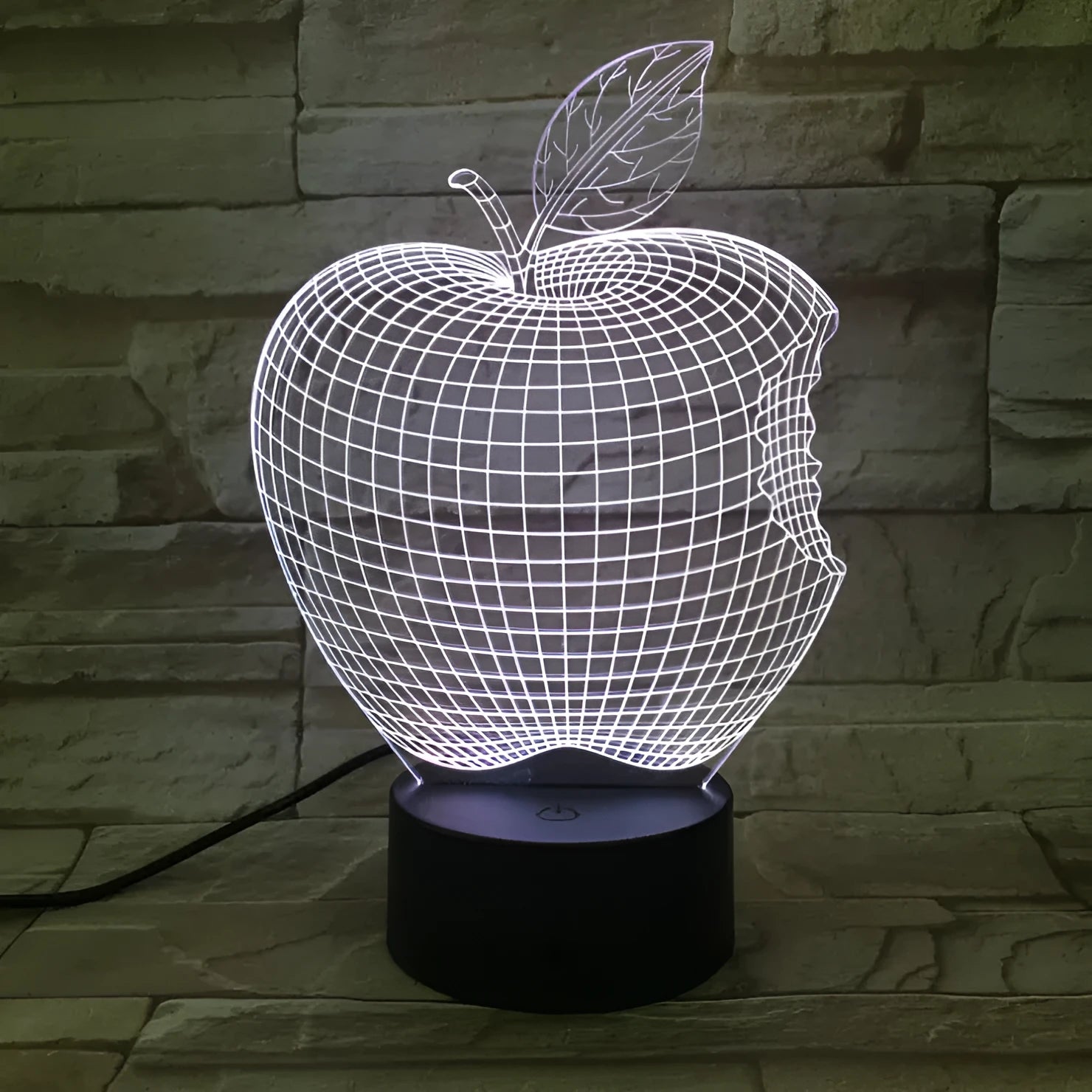 Colourful 3D fruit-shaped acrylic LED night light with touch controls on a dark surface.