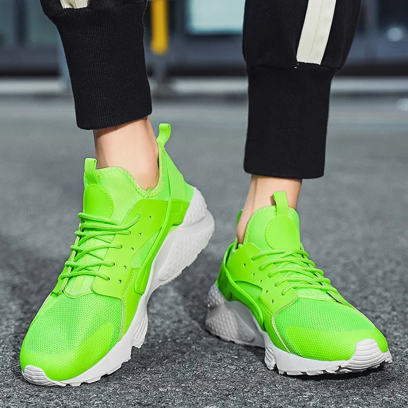Men's green mesh low-top casual shoes with cross straps and flat sole.