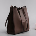Genuine leather women's bucket bag with shoulder straps showing internal organisation compartments