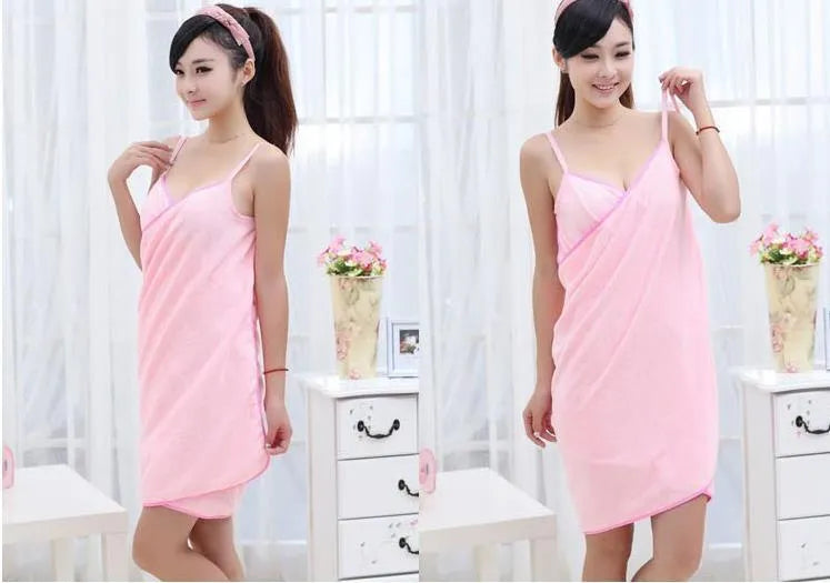 A person wearing a pink beach towel dress at the poolside, demonstrating its use as a cover-up.