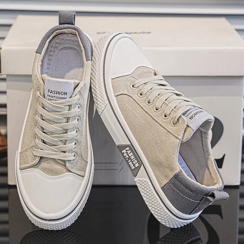 Men's low-top casual canvas skateboard shoes in blue with round toe and front lace-up closure.