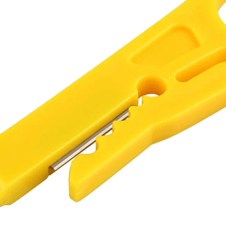 Yellow mini portable wire stripper tool for 0.6mm cables on a workbench.