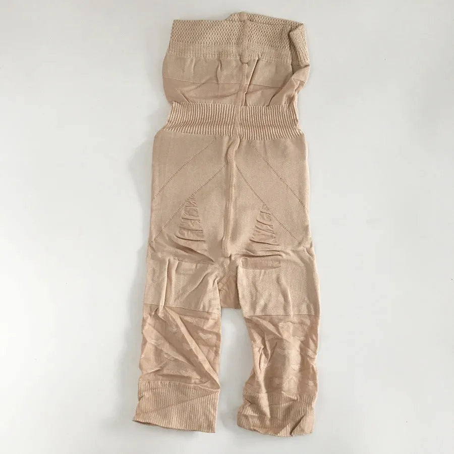 Black seamless high-waist shapewear shorts laid flat, showing the tummy control panel and leg openings.