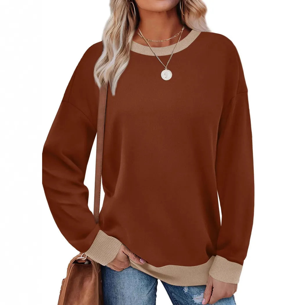 Woman wearing a loose-fitting, long-sleeved striped top with a round neckline in a choice of seven colours.