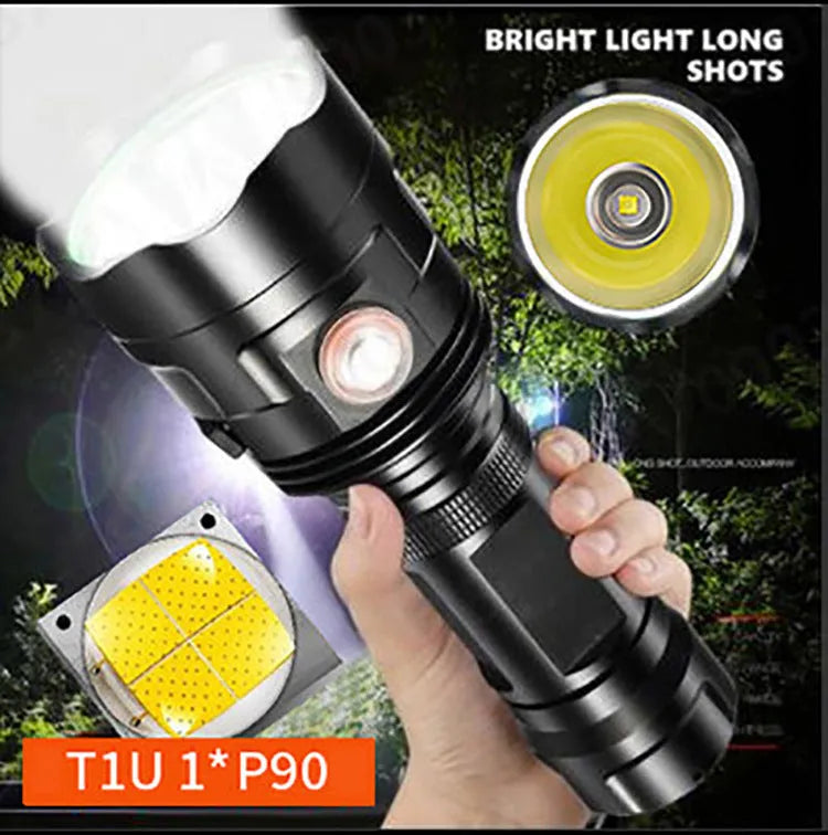 Black anodised aluminium tactical LED flashlight with a large head, shown with USB cable and yellow packaging box.