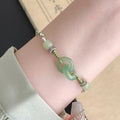 Women's ethnic style copper bracelet with peace buckle and double ring design in green.