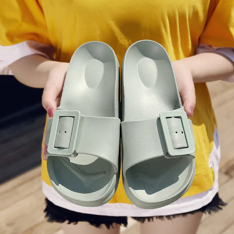 Women's grey blue EVA slippers with a buckle strap and soft sole on a white background