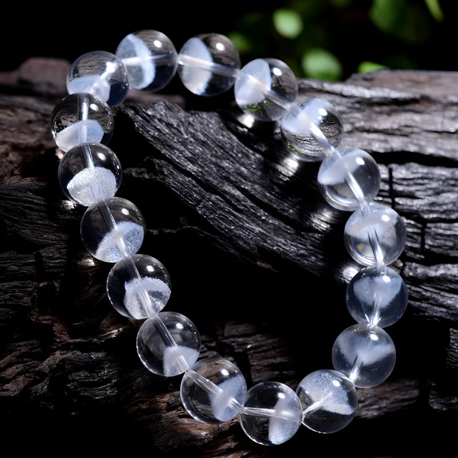 Women's white crystal pyramid bead bracelet with Ruyi design motif on a wrist.