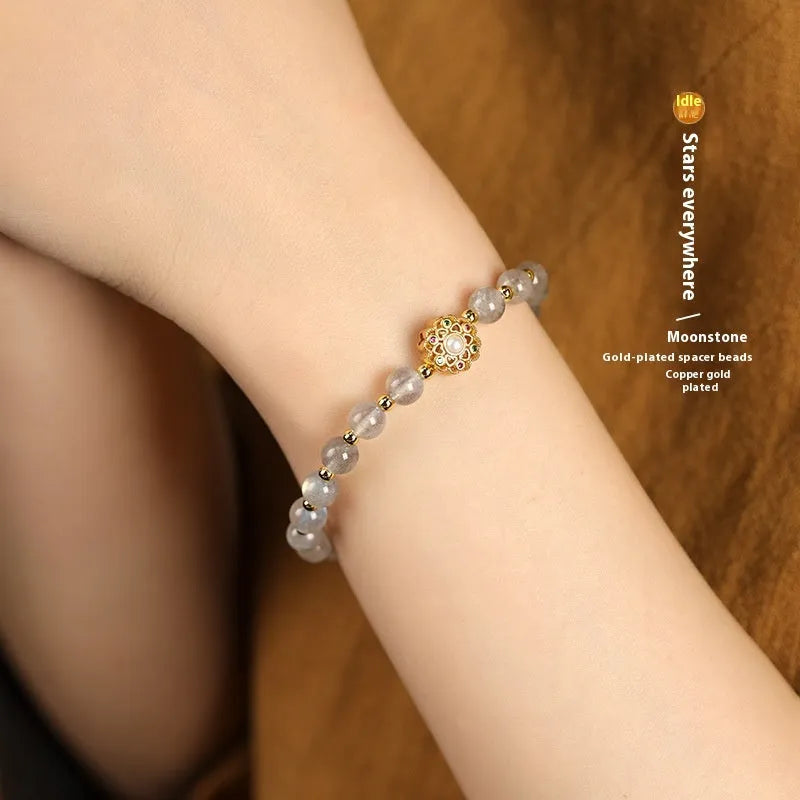 Gray moonstone and pink sunstone crystal bracelet with hand-woven cord and peach blossom quartz charms.