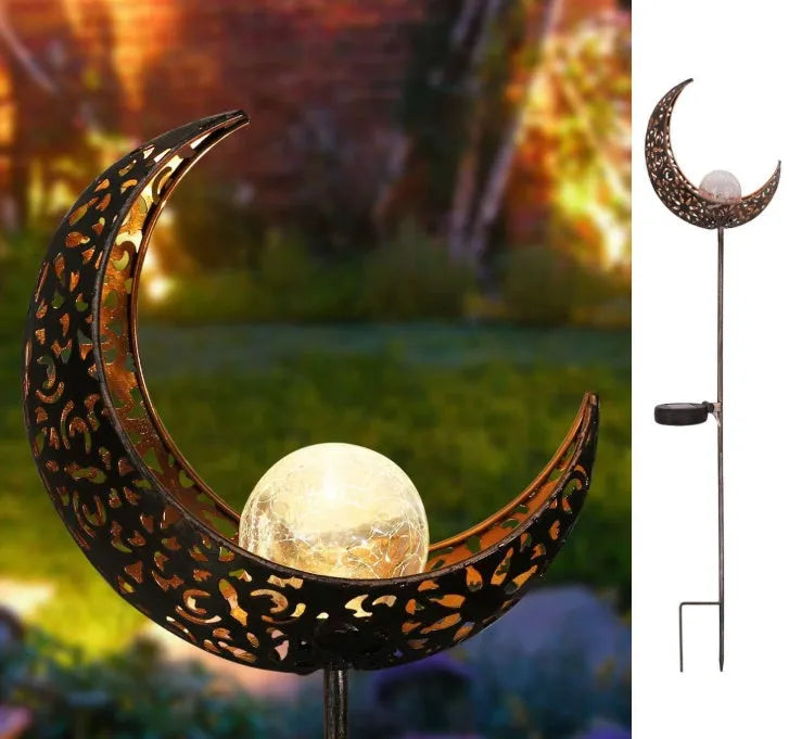 LED solar flame light with warm white glow in a garden, featuring iron and glass construction and stake stand