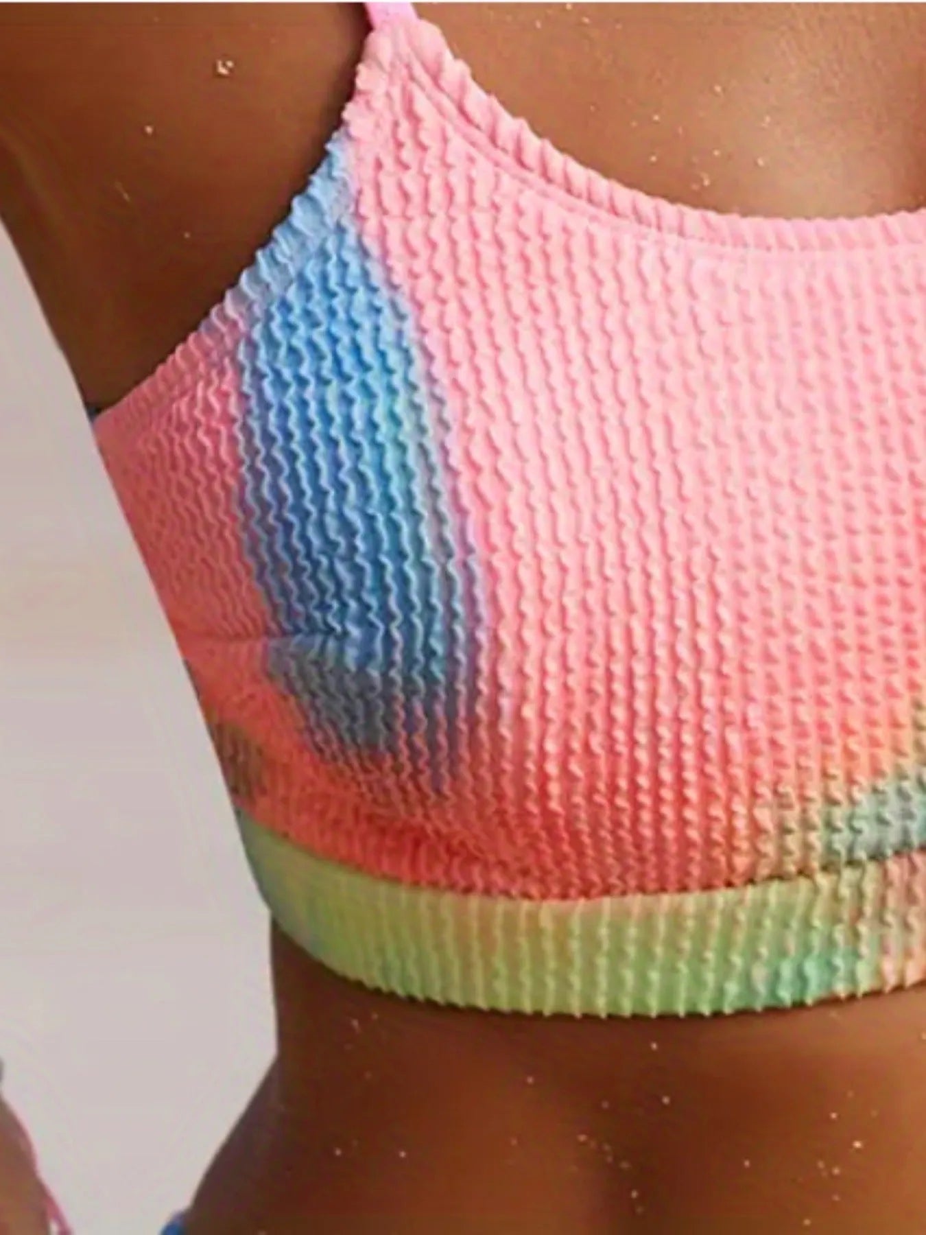 Women's blue and orange tie-dye pleated split bikini on a size chart
