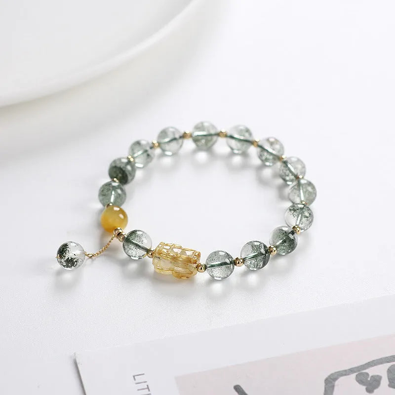 Green phantom quartz crystal bracelet with 8mm geometric beads showing gold rutile inclusions