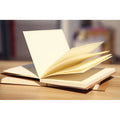 Brown and white covered kraft paper sketchbooks in 16K and 32K sizes showing binding and page detail.
