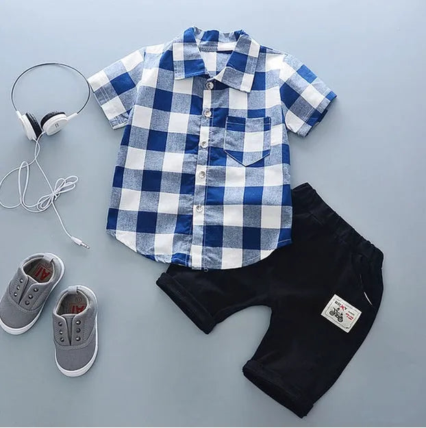 Baby boy wearing a blue crocodile print cotton short sleeve t-shirt and matching shorts summer outfit.