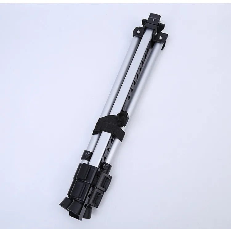 Silver aluminium alloy adjustable easel with metal tray in collapsed position on a tabletop