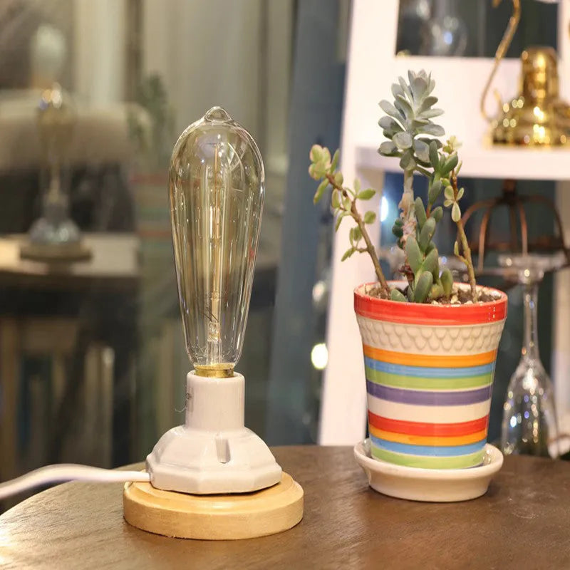Retro American country style ceramic table lamp with a wooden base and glass shade on a wooden table.