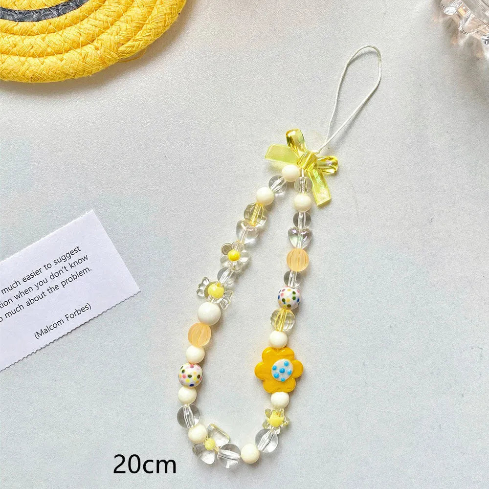Colourful beaded flower mobile phone lanyard with a hand rope loop in blue, pink, or yellow.