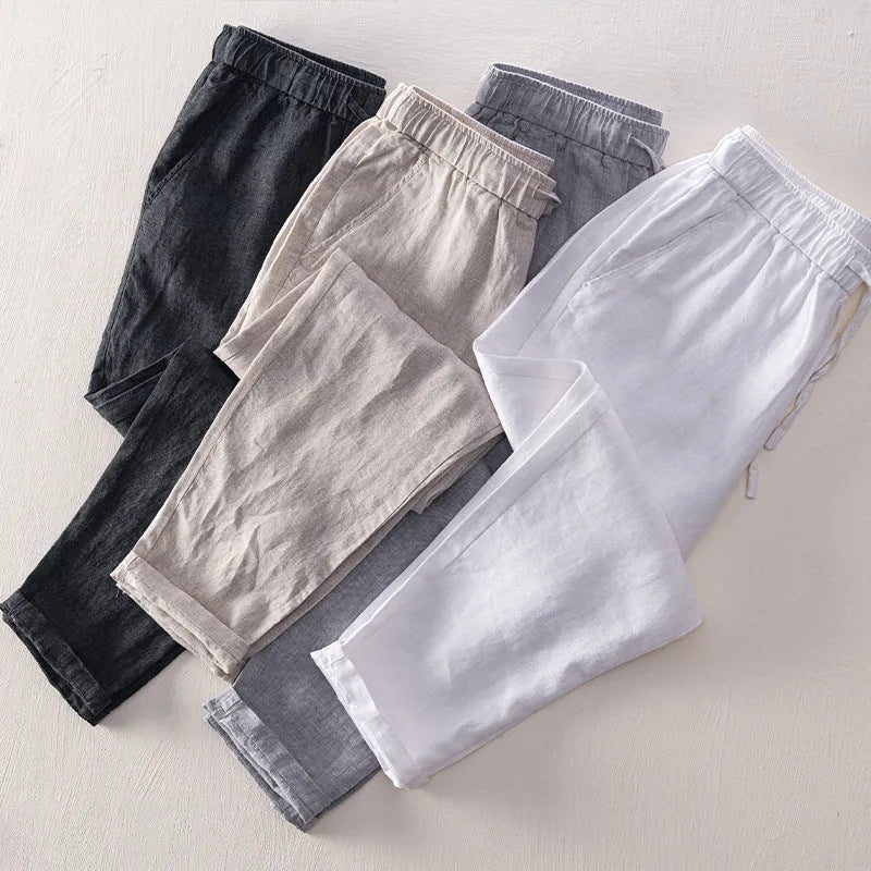 Men's straight leg linen trousers in light grey colour, showing mid waist and tailored fit.