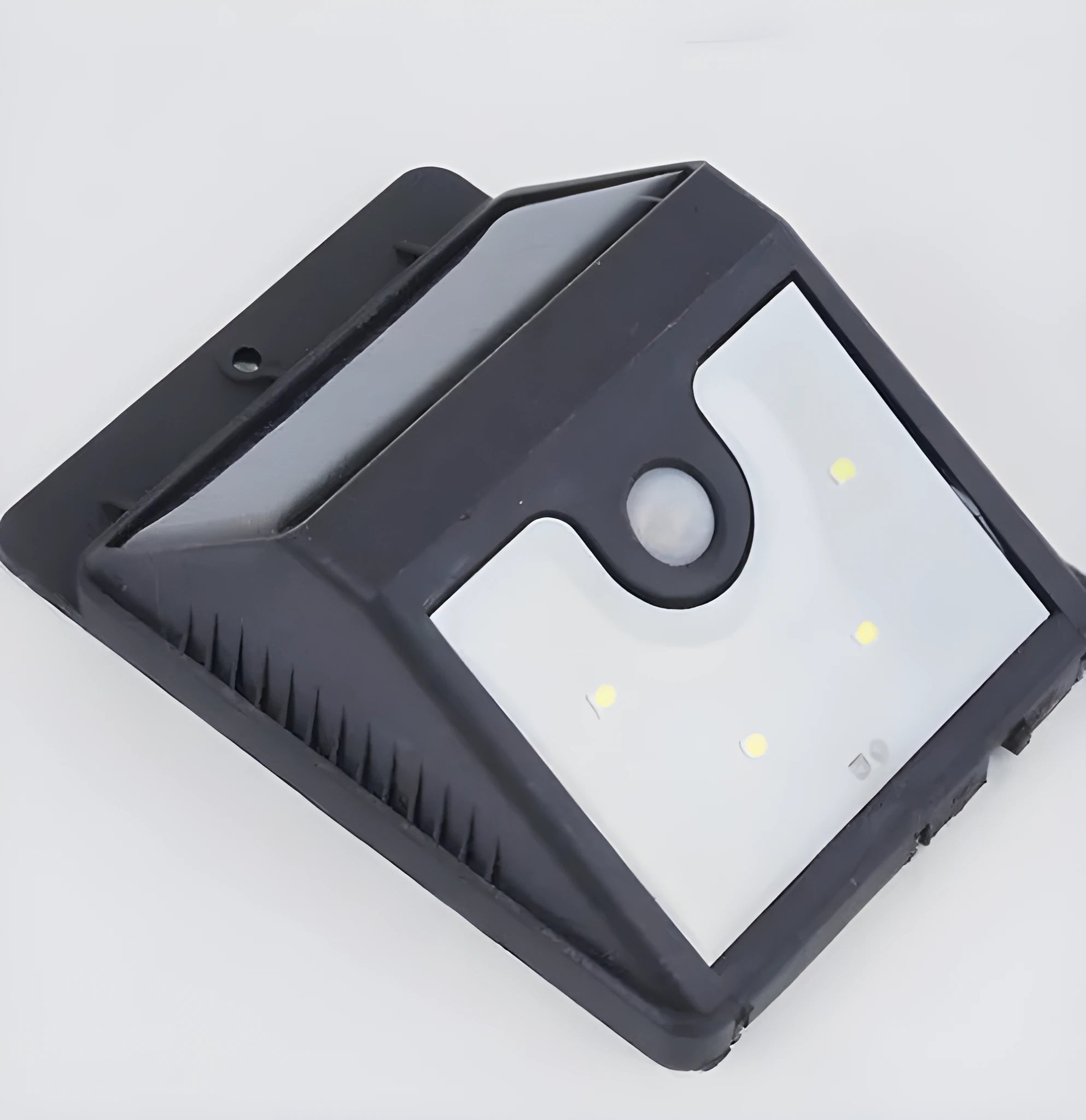 Silver outdoor solar-powered LED sensor light mounted on a wall with four illuminated bulbs.
