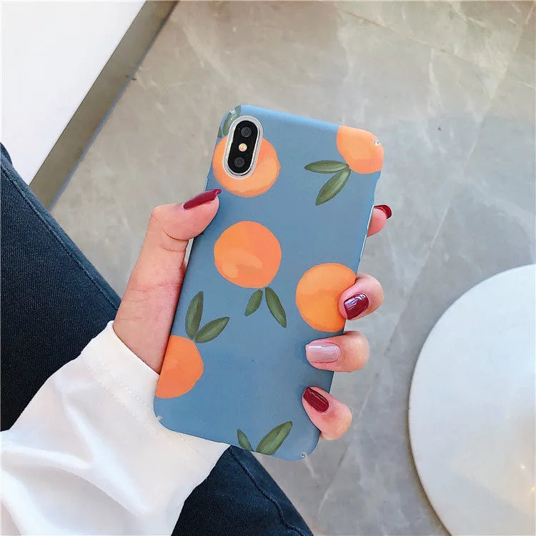 Orange and blue retro design plastic back cover case for iPhone on a table.