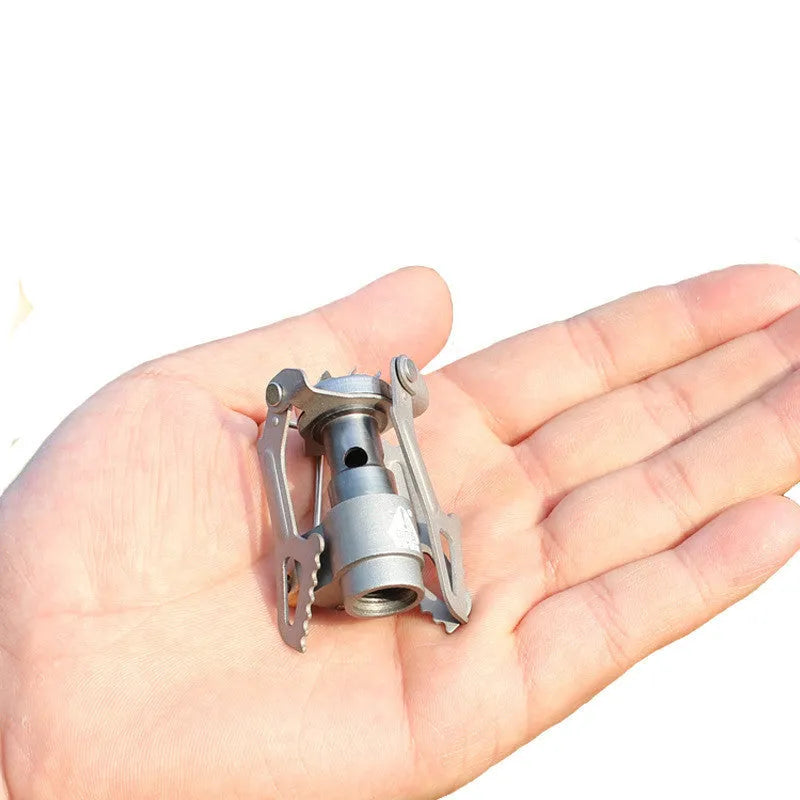 A portable propane gas camping stove with a one-piece metal furnace structure.