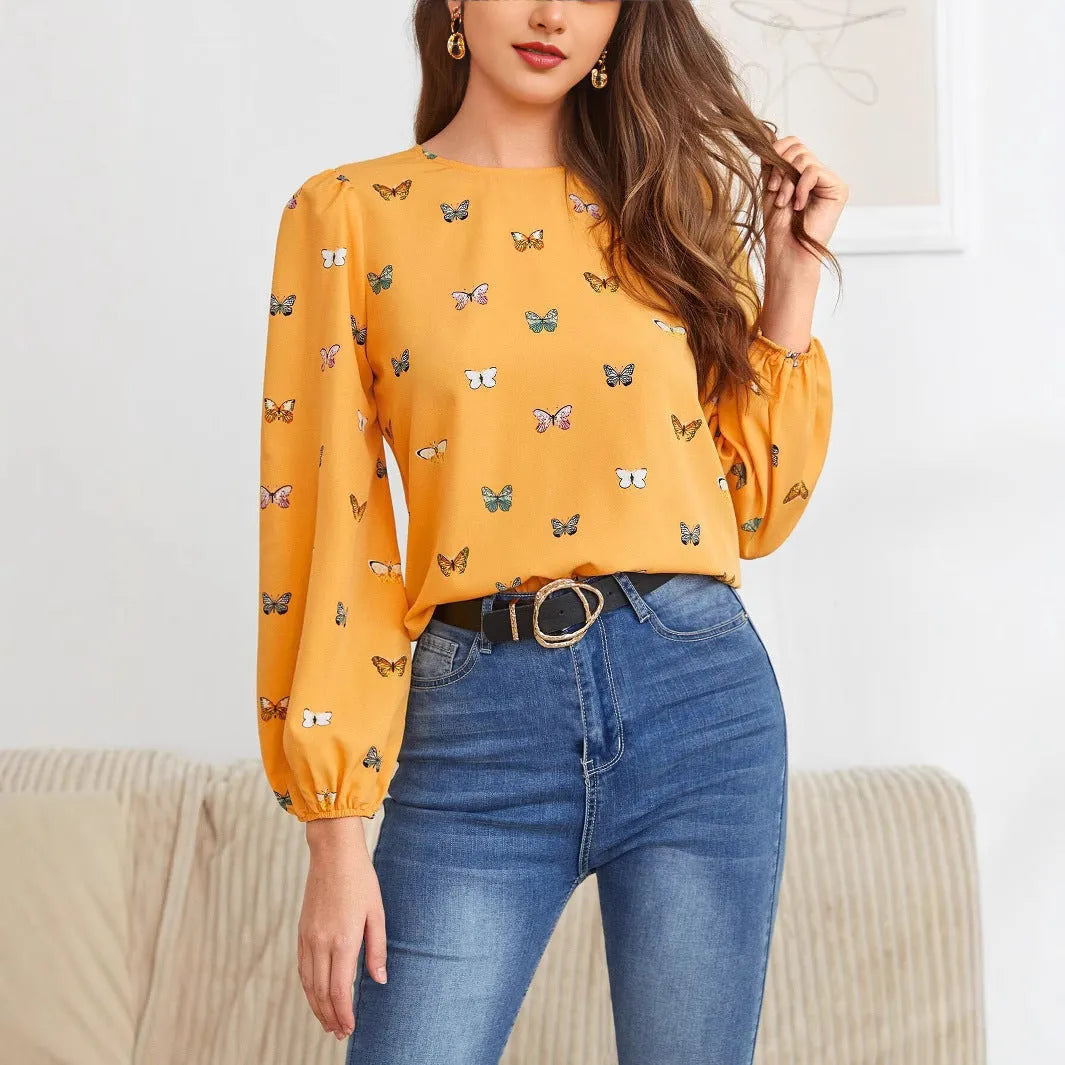 Women's green long-sleeved shirt with butterfly print pattern and loose fit.