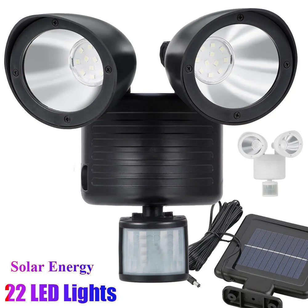 Black dual-head solar security spotlight with motion sensor mounted on exterior wall