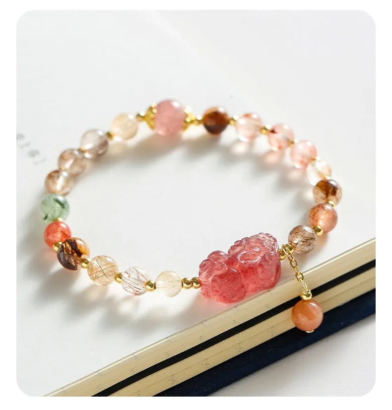 Women's strawberry quartz and copper bracelet with Pixiu charm, pearl, and dopamine crystals.