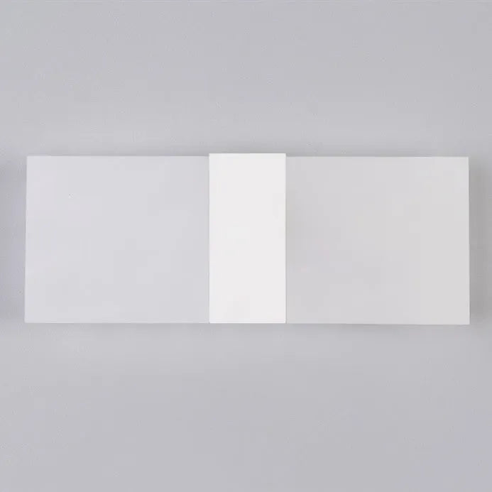 Modern acrylic LED wall lamp in silver finish showing warm light illumination