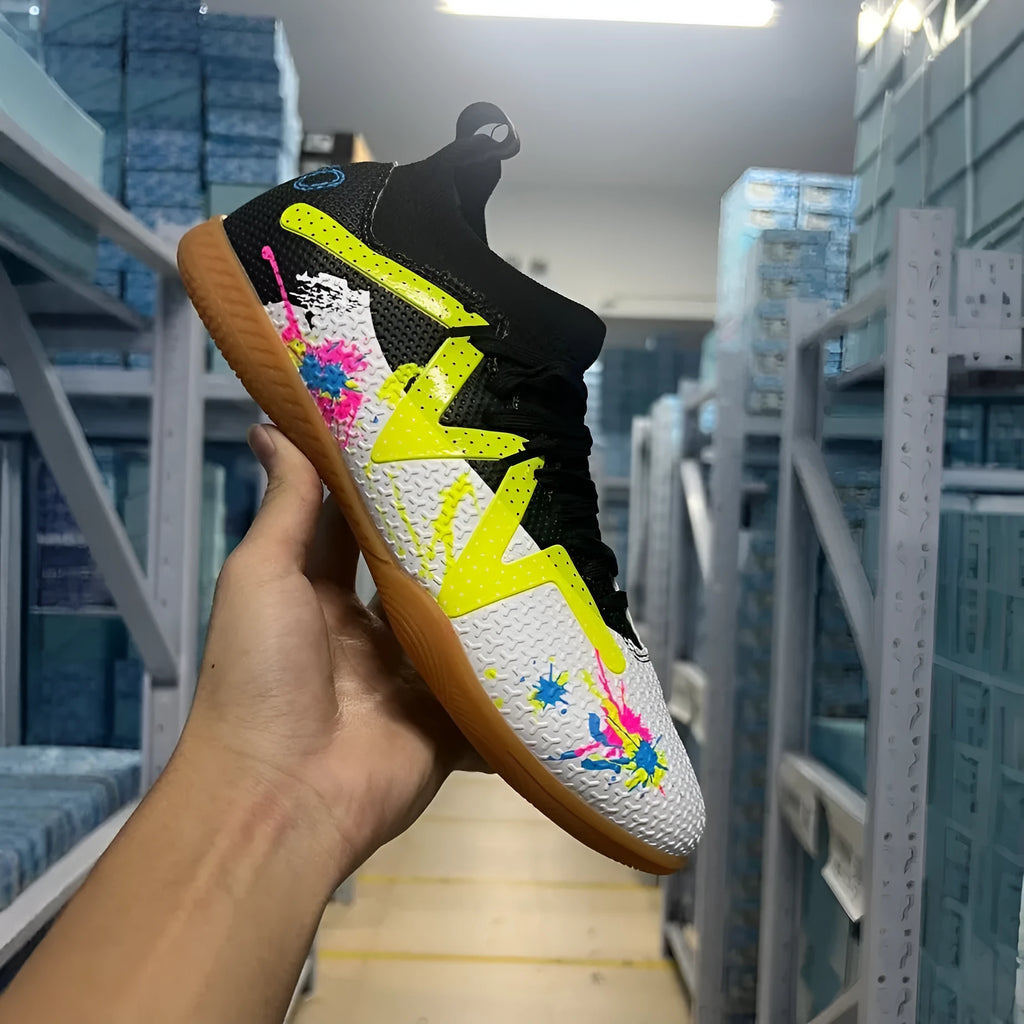Men's low top football boots with replaceable spikes in black and yellow colourway