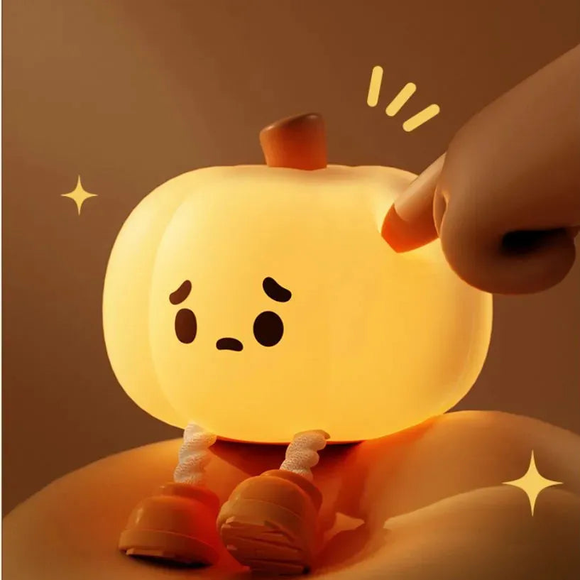 Orange pumpkin-shaped silicone night light with soft glowing illumination