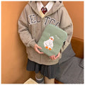 Blue cotton tablet case with cartoon duck embroidery and a zipper, shown next to a green version.