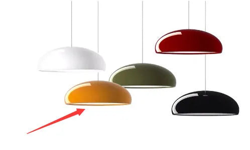 Modern Danish orange iron pendant lamp with adjustable cable over a restaurant dining table.