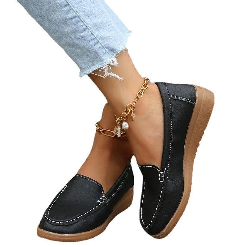 Women's flat loafer shoe in PU leather with car suture detail and a round toe, shown in a choice of colours.