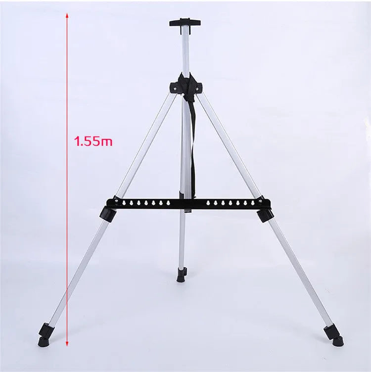 Silver aluminium alloy adjustable easel with metal tray in collapsed position on a tabletop