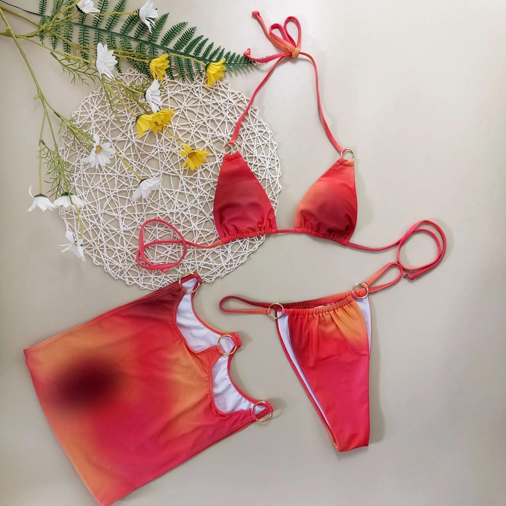 Solid colour tie-dye gradient three-piece halter bikini set with skirt on a mannequin.