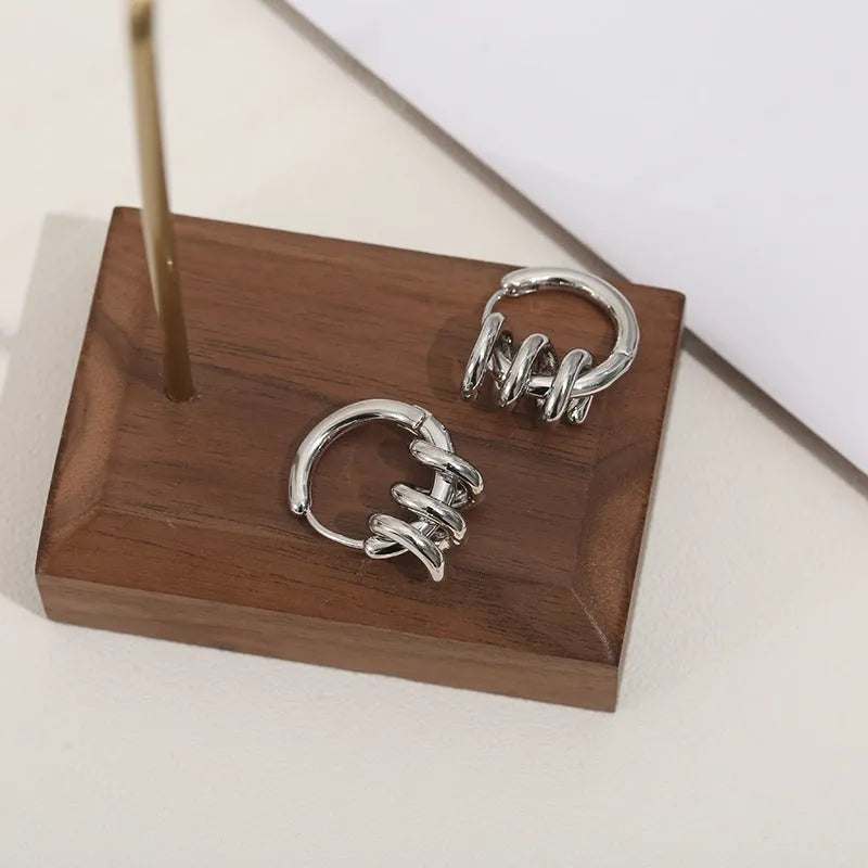 Spiral wound ear clip earrings in frosted geometric shape, copper with gold or silver plating, 1.75cm by 2.16cm.