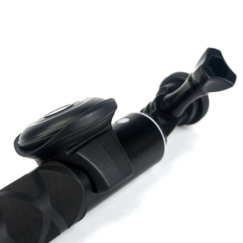 Black Snap Bluetooth remote control for wireless phone photography on a white background.